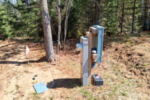 Wooded 8-acre property for sale in Rhinelander with mature trees, direct access to adjoining Wisconsin State Land, and 30x50 concrete pad ready for construction.